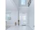 Bright entryway with high ceilings, white door, and light gray walls at 5045 Rain Shadow Dr, St Cloud, FL 34772