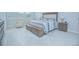 Main bedroom with king-size bed, two armchairs and neutral decor at 5045 Rain Shadow Dr, St Cloud, FL 34772