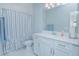 Neat bathroom with a single vanity, shower, and white cabinets at 5045 Rain Shadow Dr, St Cloud, FL 34772