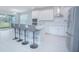Spacious kitchen with island seating and sliding glass doors to patio at 5045 Rain Shadow Dr, St Cloud, FL 34772