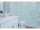 Clean bathroom with white vanity, toilet, and a glass shower at 5045 Rain Shadow Dr, Saint Cloud, FL 34772