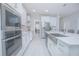 Bright kitchen featuring stainless steel appliances and a farmhouse sink at 5045 Rain Shadow Dr, St Cloud, FL 34772