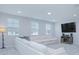 Bright living area featuring a sectional sofa and large TV at 5045 Rain Shadow Dr, St Cloud, FL 34772