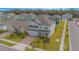 Two-story house with gray exterior, a brick driveway, and a landscaped lawn at 5045 Rain Shadow Dr, St Cloud, FL 34772