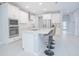 Modern kitchen with white cabinets, stainless steel appliances, and an island at 5045 Rain Shadow Dr, St Cloud, FL 34772