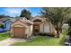 Front view of house with attached garage at 6525 Spring Land Ct, Orlando, FL 32818