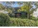 Charming two-story house with a red door, surrounded by lush greenery at 706 E Pine St # 5, Orlando, FL 32801