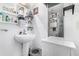 Small bathroom with pedestal sink, shower, and storage at 706 E Pine St # 5, Orlando, FL 32801