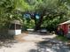 Gravel driveway with mature trees and outbuildings at 780 Snow Hill Rd, Geneva, FL 32732