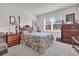 Bright bedroom with floral bedding and wood furniture at 1178 Michelangelo Ln, Winter Haven, FL 33884