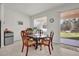 Cozy breakfast nook with a round table and four chairs near sliding door at 1178 Michelangelo Ln, Winter Haven, FL 33884