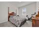 Bright bedroom with a four-poster bed and window seat at 1178 Michelangelo Ln, Winter Haven, FL 33884