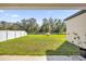 Large backyard with green grass and a white fence at 1178 Michelangelo Ln, Winter Haven, FL 33884