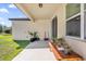 Covered patio with seating area and potted plants at 1178 Michelangelo Ln, Winter Haven, FL 33884
