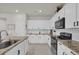 Modern kitchen with white cabinets and granite countertops at 1178 Michelangelo Ln, Winter Haven, FL 33884