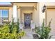 Inviting front porch with decorative seating and greenery at 1178 Michelangelo Ln, Winter Haven, FL 33884