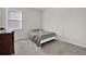Simple bedroom with a metal bed frame and a window with blinds at 1178 Michelangelo Ln, Winter Haven, FL 33884