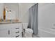 Bathroom with granite countertop, white cabinets, and shower/tub combo at 1178 Michelangelo Ln, Winter Haven, FL 33884
