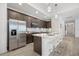 Modern kitchen features stainless steel appliances and dark brown cabinetry at 14269 Shocklach Dr, Winter Garden, FL 34787