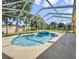 Inviting kidney-shaped pool with a spa and screened enclosure at 714 Terranova Ave, Winter Haven, FL 33884