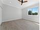 Well-lit bedroom featuring wood-look floors, a window, and a ceiling fan at 1333 W Smith St, Orlando, FL 32804