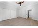 Spacious bedroom with wood-look floors, ceiling fan, and ample closet space at 1333 W Smith St, Orlando, FL 32804