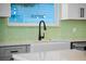Modern kitchen sink with a sleek, black faucet and green tile backsplash at 1333 W Smith St, Orlando, FL 32804