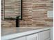 Modern bathroom sink with a sleek black faucet and stone tile at 1333 W Smith St, Orlando, FL 32804