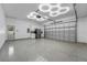 Modern garage with epoxy flooring, built-in cabinets, and a refrigerator at 1333 W Smith St, Orlando, FL 32804