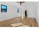 Spacious bedroom with hardwood floors, ceiling fan, and access to bathroom at 1333 W Smith St, Orlando, FL 32804