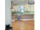 Bright kitchen boasts white cabinets, light hardwood floors, and green tile at 1333 W Smith St, Orlando, FL 32804