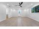 Spacious bedroom with wood-look floors, a ceiling fan, and an exterior door at 1333 W Smith St, Orlando, FL 32804