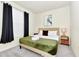 Bedroom with king bed, green blanket, and window coverings at 287 Jetty Way, Davenport, FL 33897