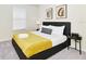Bedroom with queen bed, yellow blanket, and window coverings at 287 Jetty Way, Davenport, FL 33897