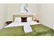 Bedroom with king-size bed, green blanket, and side table at 287 Jetty Way, Davenport, FL 33897