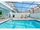 Relaxing pool area with patio furniture and grill at 287 Jetty Way, Davenport, FL 33897