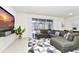 Spacious living room with large sectional sofa and TV at 287 Jetty Way, Davenport, FL 33897
