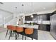 Kitchen island with seating, stainless steel appliances, and granite countertops at 287 Jetty Way, Davenport, FL 33897