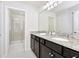 Bathroom with double vanity, granite countertop and walk-in shower at 287 Jetty Way, Davenport, FL 33897