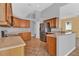 Kitchen with wood cabinets, tile floor, and stainless steel appliances at 4538 Nottoway Dr, Leesburg, FL 34748