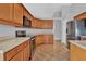 Well-equipped kitchen featuring wood cabinets and appliances at 4538 Nottoway Dr, Leesburg, FL 34748