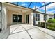 Spacious screened-in porch with sliding glass doors and ceiling fan at 4538 Nottoway Dr, Leesburg, FL 34748