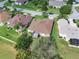 Aerial view of a house with brown roof and screened patio at 4538 Nottoway Dr, Leesburg, FL 34748