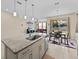 Modern kitchen with island, granite countertops, stainless steel appliances, and breakfast bar at 528 Bellissimo Pl, Howey In The Hills, FL 34737