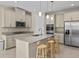 Modern kitchen with granite countertops, stainless steel appliances, and an island at 528 Bellissimo Pl, Howey In The Hills, FL 34737