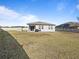 Large backyard with grassy area, shed, and grilling space at 528 Bellissimo Pl, Howey In The Hills, FL 34737