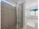 Walk-in shower with tile surround and glass enclosure at 528 Bellissimo Pl, Howey In The Hills, FL 34737