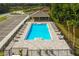 Aerial view of community pool with surrounding patio and landscaping at 2026 Red Rock Rd, New Smyrna Beach, FL 32168