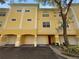 Three-story building with yellow exterior and attached garages at 1711 Shadow View Cir # 1711, Maitland, FL 32751