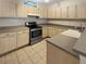 Modern kitchen with stainless steel appliances and light wood cabinets at 1711 Shadow View Cir # 1711, Maitland, FL 32751